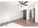 Bright bedroom features wood floors, neutral walls, a ceiling fan, and a sliding door closet at 912 Pro Players Dr, Las Vegas, NV 89134