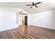 Spacious bedroom with wood floors, neutral walls, a ceiling fan, and open doorway at 912 Pro Players Dr, Las Vegas, NV 89134