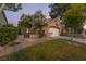 Charming single-Gathering home with a well-manicured lawn, mature trees, and an attached two-car garage at 912 Pro Players Dr, Las Vegas, NV 89134