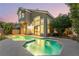Exterior of the home and backyard pool and spa during sunset at 912 Pro Players Dr, Las Vegas, NV 89134