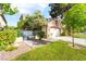 House exterior featuring manicured green lawns, mature trees, and an enclosed yard with a gate at 912 Pro Players Dr, Las Vegas, NV 89134