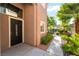 Inviting home entrance with a dark front door, and well-maintained landscaping at 912 Pro Players Dr, Las Vegas, NV 89134
