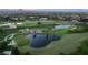 Expansive aerial view of a lush green golf course with ponds and manicured landscaping under a scenic mountain backdrop at 912 Pro Players Dr, Las Vegas, NV 89134