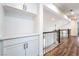 Upstairs hallway with hardwood floors, built in cabinets, and a view of the main floor adds charm at 912 Pro Players Dr, Las Vegas, NV 89134