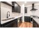 Modern kitchen with stainless steel appliances, black cabinetry, and white backsplash at 912 Pro Players Dr, Las Vegas, NV 89134