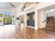 Bright living room with hardwood floors, fireplace, high ceilings and expansive windows with backyard view at 912 Pro Players Dr, Las Vegas, NV 89134