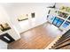 Bright living room with hardwood floors, black door, staircase, and view of pool and backyard at 912 Pro Players Dr, Las Vegas, NV 89134