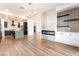 Open-concept living space with fireplace, modern light fixture, and seamless flow to the kitchen at 912 Pro Players Dr, Las Vegas, NV 89134