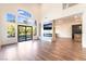 Open-concept living space featuring a modern fireplace, hardwood floors, and pool view at 912 Pro Players Dr, Las Vegas, NV 89134