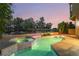 Inviting backyard pool and spa area with tiled accents and lush landscaping, perfect for relaxation at 912 Pro Players Dr, Las Vegas, NV 89134