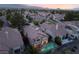 Beautiful home featuring a backyard pool, complemented by mature trees and landscaping at 912 Pro Players Dr, Las Vegas, NV 89134
