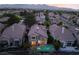 Aerial view of a home with a private pool, nestled in a neighborhood with mountain views at 912 Pro Players Dr, Las Vegas, NV 89134