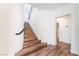 Elegant curved staircase with wood steps, black railings, and glass block window creates a bright entryway at 912 Pro Players Dr, Las Vegas, NV 89134