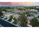 Serene neighborhood street featuring houses with lush landscaping and access to a nearby golf course at 912 Pro Players Dr, Las Vegas, NV 89134