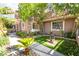 Landscaped yard with mature trees, shrubs, and a water fountain feature on artificial turf at 912 Pro Players Dr, Las Vegas, NV 89134