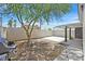 Large, private backyard features a patio area, mature tree, and grill perfect for outdoor entertaining at 9151 Indian Breeze Dr, Las Vegas, NV 89129