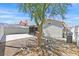Landscaped backyard featuring gravel and stone accents with a built-in barbecue and covered patio at 9151 Indian Breeze Dr, Las Vegas, NV 89129