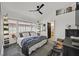 Comfortable bedroom features a ceiling fan, large window and is decorated in black and white at 9151 Indian Breeze Dr, Las Vegas, NV 89129