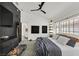 Modern bedroom boasts neutral color scheme, a black accent wall, and access to an ensuite bathroom at 9151 Indian Breeze Dr, Las Vegas, NV 89129