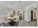 Open dining area features a stylish table, modern lighting, and views of the kitchen at 9151 Indian Breeze Dr, Las Vegas, NV 89129