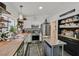 Updated kitchen with a butcher block countertops, open shelving, and stainless steel appliances at 9151 Indian Breeze Dr, Las Vegas, NV 89129