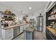 Well-lit kitchen featuring white cabinets, open shelving, and stainless steel appliances at 9151 Indian Breeze Dr, Las Vegas, NV 89129