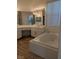 Bathroom featuring a soaking tub and vanity with ample storage at 9728 Echo Hills Dr, Las Vegas, NV 89134