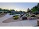 Picturesque community path lined with desert landscaping and a stone wall, creating a serene outdoor space at 9728 Echo Hills Dr, Las Vegas, NV 89134