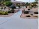 Landscaped front yard with lush greenery, a charming bridge, and inviting benches at 9728 Echo Hills Dr, Las Vegas, NV 89134