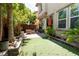 Backyard featuring a grass area, a brick patio, and mature landscaping at 10526 Harvest Wind Dr, Las Vegas, NV 89135
