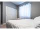Bright bedroom features a large closet with a sliding door and lots of natural light from large windows at 10526 Harvest Wind Dr, Las Vegas, NV 89135