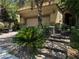 Inviting home exterior featuring stone accents, a brick driveway, and lush landscaping at 10526 Harvest Wind Dr, Las Vegas, NV 89135