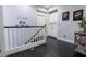 Upstairs hallway featuring dark hardwood floors and a white banister at 10526 Harvest Wind Dr, Las Vegas, NV 89135