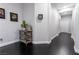 Hallway featuring dark hardwood floors, gray walls, and decorative wall art at 10526 Harvest Wind Dr, Las Vegas, NV 89135