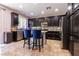 Dark wood cabinets, stainless steel appliances, tile backsplash, and granite countertops in kitchen at 10526 Harvest Wind Dr, Las Vegas, NV 89135