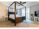 Bedroom features a four-poster bed, ceiling fan, and plantation shutters for natural light at 10526 Harvest Wind Dr, Las Vegas, NV 89135