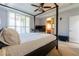 Main bedroom with ceiling fan and natural light from a large window at 10526 Harvest Wind Dr, Las Vegas, NV 89135