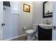 Compact powder room with modern fixtures, sink, toilet, and neutrally painted walls at 10526 Harvest Wind Dr, Las Vegas, NV 89135