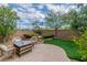 Landscaped backyard featuring a sitting area with an outdoor table at 10987 Santorini Dr, Las Vegas, NV 89141