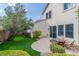 Charming backyard with lush lawn, patio, and manicured landscaping at 10987 Santorini Dr, Las Vegas, NV 89141
