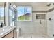 Modern bathroom with a tiled shower, glass door, and updated fixtures plus view from window at 10987 Santorini Dr, Las Vegas, NV 89141