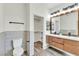 Modern bathroom with double sinks, wood cabinets, and shower stall with tiled walls and floors at 10987 Santorini Dr, Las Vegas, NV 89141