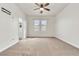 Large bedroom featuring neutral colored carpet, ceiling fan, and a pair of windows providing ample natural light at 10987 Santorini Dr, Las Vegas, NV 89141