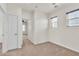 Empty bedroom with neutral walls, carpet, and two windows with views of outside at 10987 Santorini Dr, Las Vegas, NV 89141