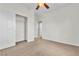 Comfortable bedroom with neutral carpet, ceiling fan, and a spacious closet for storage at 10987 Santorini Dr, Las Vegas, NV 89141