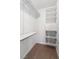 Walk-in closet featuring wire basket drawers, built-in shelving, and neutral carpeting at 10987 Santorini Dr, Las Vegas, NV 89141
