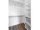 Walk-in closet with wire basket drawers, white shelving, and hardwood flooring at 10987 Santorini Dr, Las Vegas, NV 89141