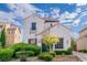 Two-story home featuring landscaped yard, garden, and tile roof under beautiful sky at 10987 Santorini Dr, Las Vegas, NV 89141