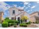 Charming two-story home featuring landscaped yard and tile roof against a beautiful sky at 10987 Santorini Dr, Las Vegas, NV 89141