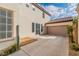 Attached garage with a wide driveway and tile roof at 10987 Santorini Dr, Las Vegas, NV 89141